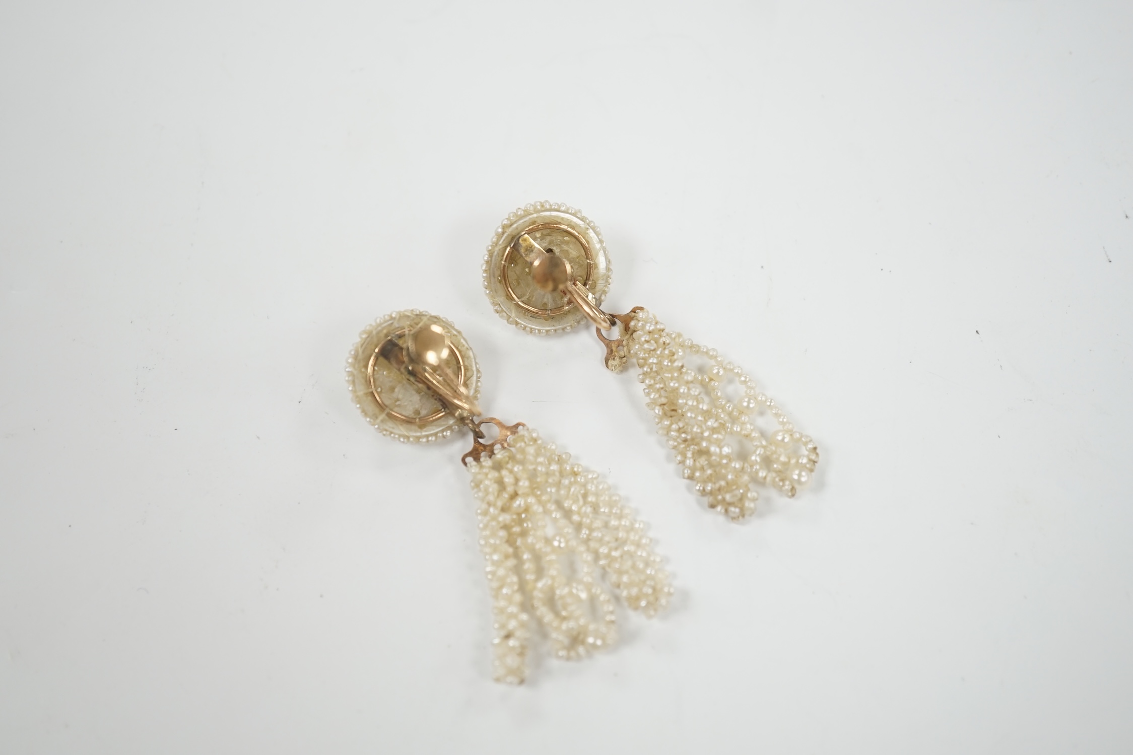 A pair of 19th century yellow metal and seed pearl cluster set tassel drop ear clips, 47mm.